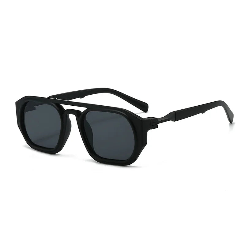 Clear frame sunglasses with pink gradient lens and vibrant orange arm detail, acetate beach eyewear close up.