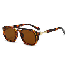 Clear frame sunglasses with pink tinted lens and orange acetate arm detail close up