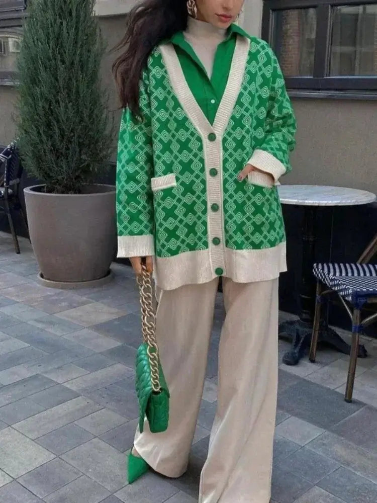 Model wearing a Knitted Oversized V Neck Long Sleeve Cardigan in green with white patterns, paired with wide-leg pants and matching bag