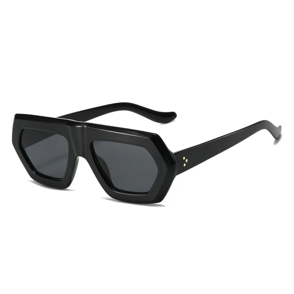 Oversized color block sunglasses with amber tortoiseshell frame and gradient lens detail shot.