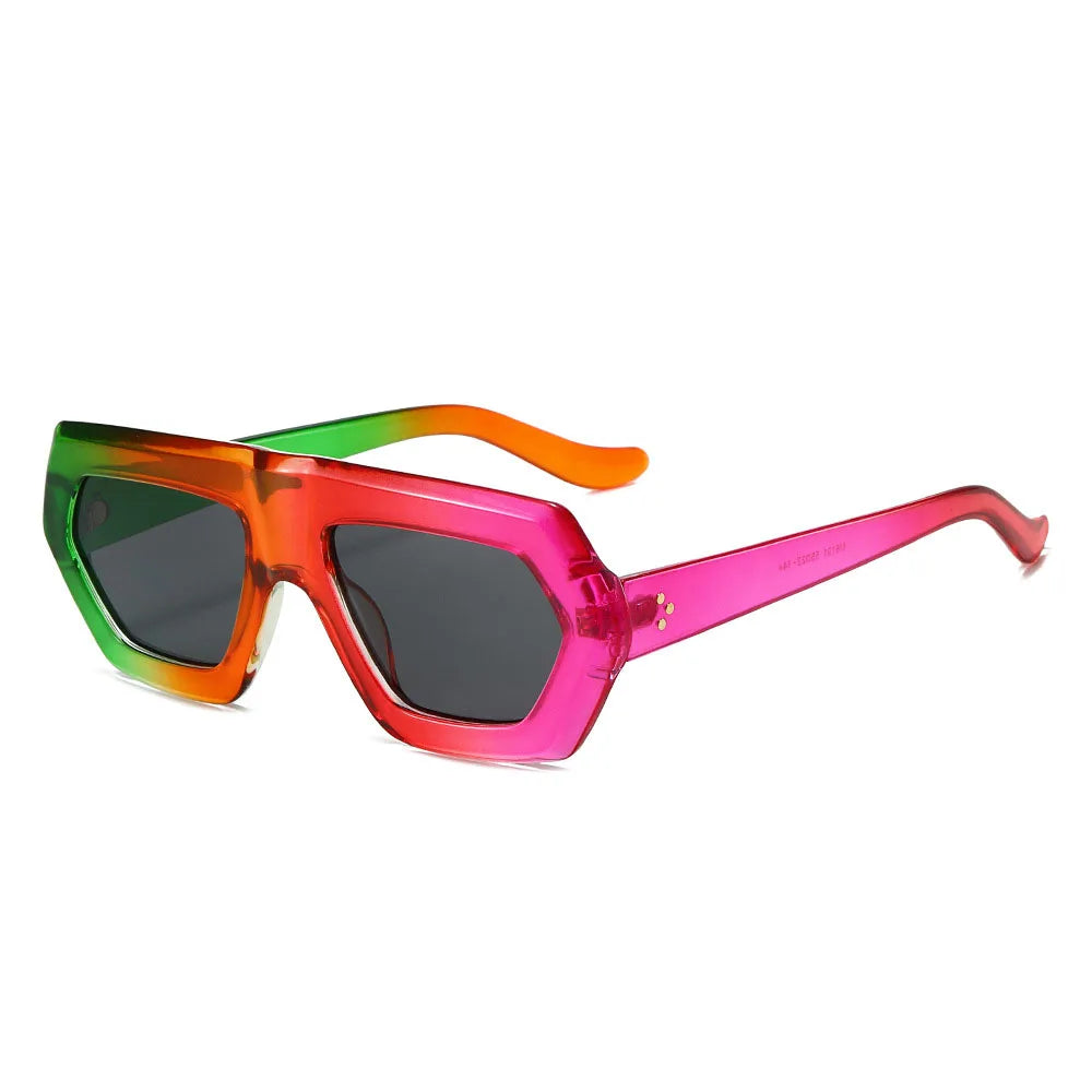 Oversized color block sunglasses with amber tortoiseshell frame and gradient lens detail close up