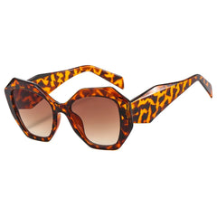 Oversized hexagon sunglasses in tortoiseshell amber with green gradient lens detail and material texture closeup