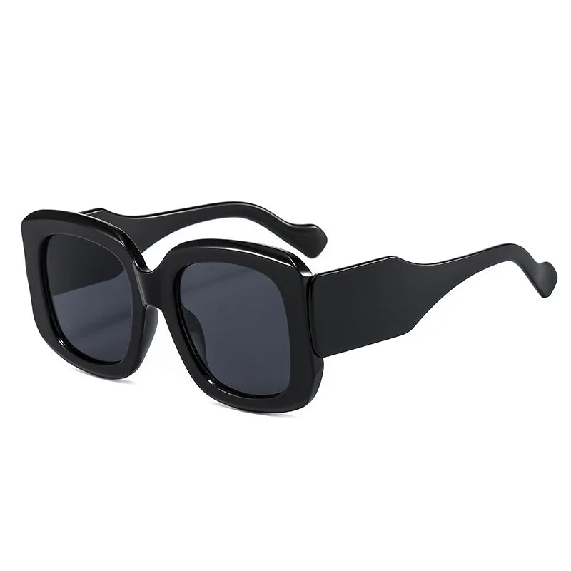 Oversized square resin sunglasses with gradient colorway, highlighting chunky frame details and UV protection.