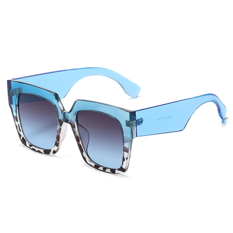 Oversized square sunglasses with blue tortoiseshell gradient lens detail and bold frame design