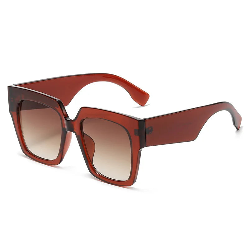 Oversized square sunglasses with blue tortoiseshell gradient lens detail and bold frame material close-up
