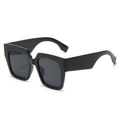Oversized square sunglasses with blue tortoiseshell pattern and gradient lens detail close-up