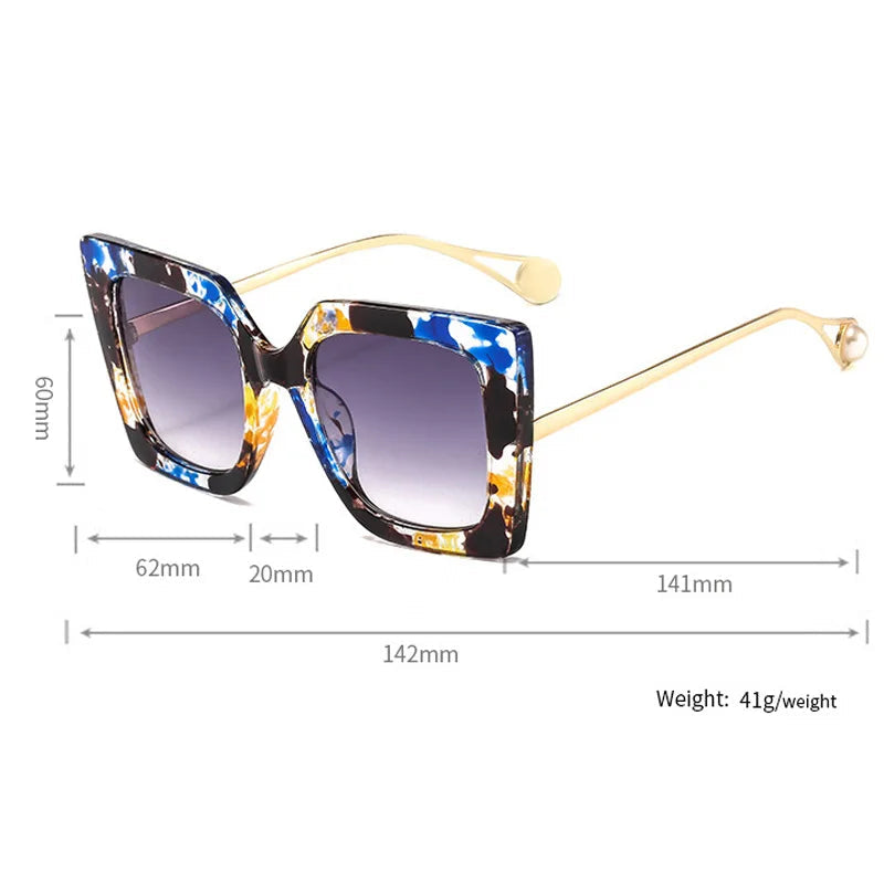 Oversized square sunglasses with gradient lens and gold acetate arm detail close up