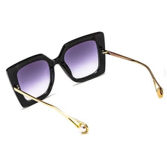Oversized square sunglasses with gradient lens and gold acetate arms, bold tortoiseshell frame detail.
