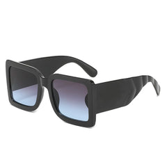 Oversized square sunglasses with mint vegan leather arms and bold black frame detail