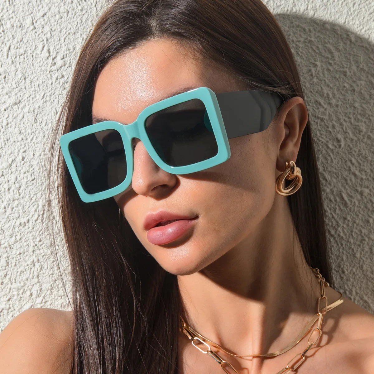 Oversized square sunglasses with mint vegan leather arms and bold black frame detail