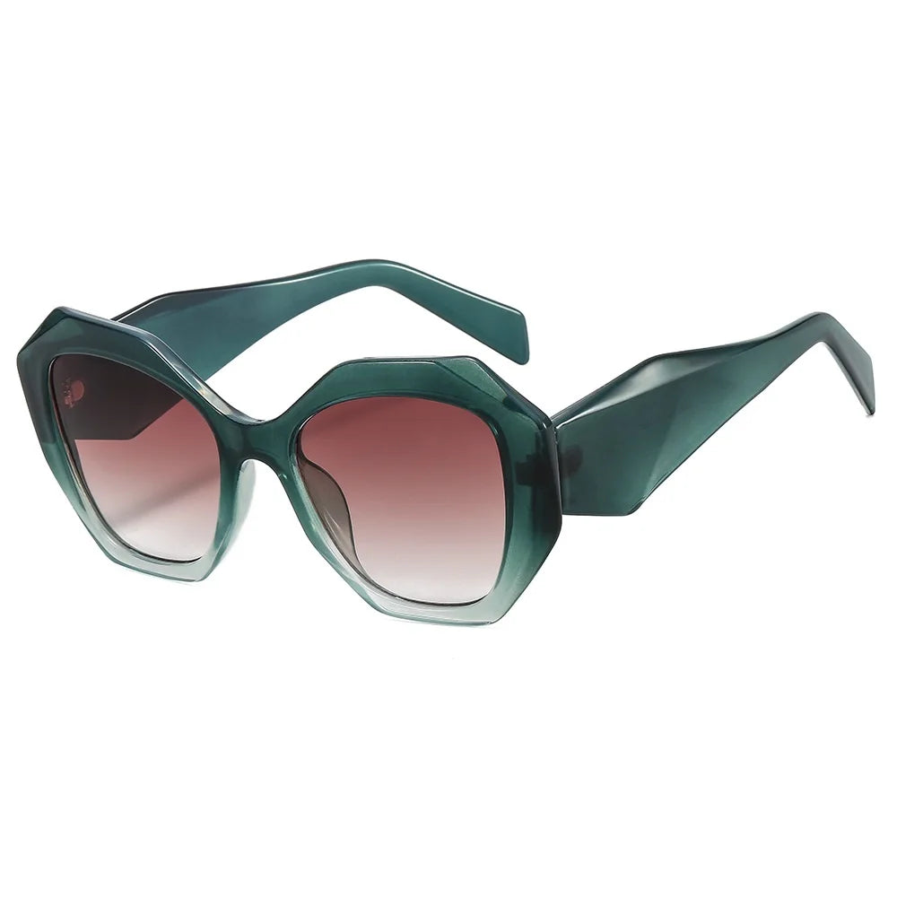 Oversized tortoiseshell hexagon sunglasses with green gradient lens detail and bold frame material close-up
