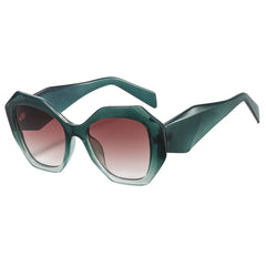 Oversized tortoiseshell hexagon sunglasses with green gradient lens detail and bold frame material close-up