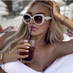 Oversized tortoiseshell hexagon sunglasses with green gradient lenses detail shot showcasing frame material and lens color.