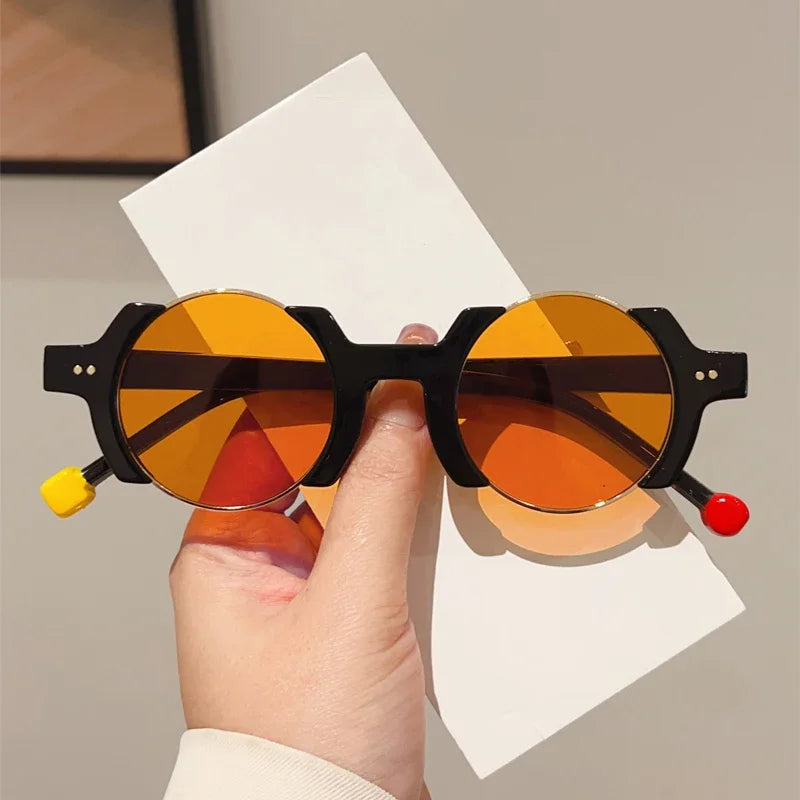 Round frame sunglasses with colorful bubble detail and blue tinted lenses, close up angle