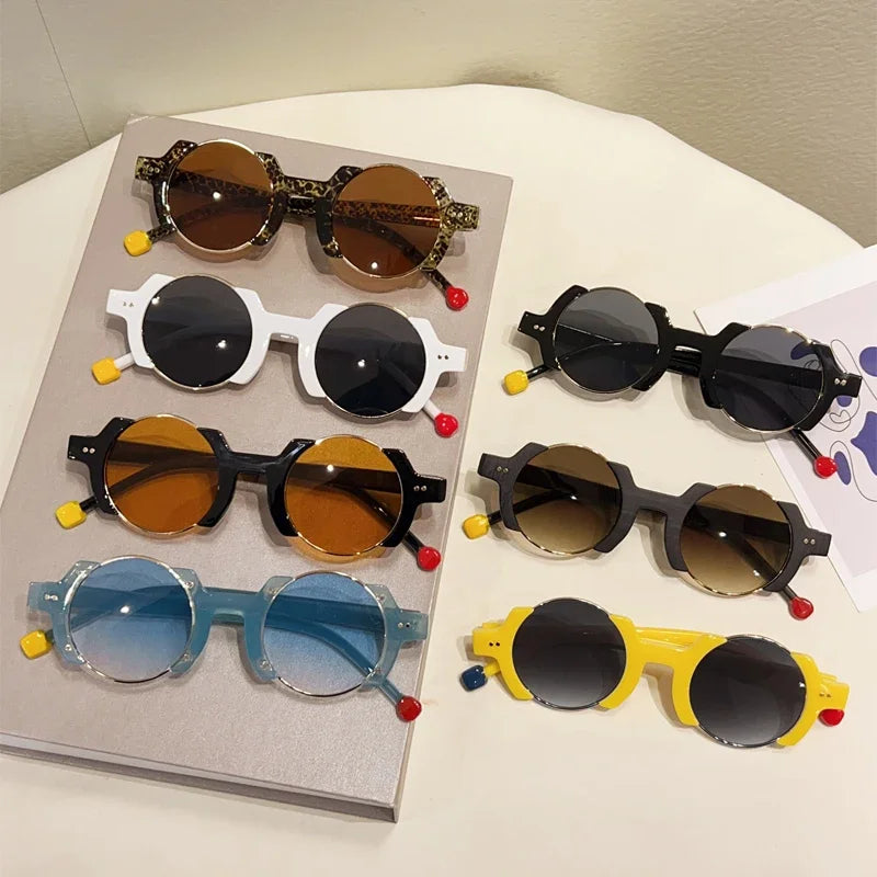 Round frame sunglasses with colorful bubble detail and blue tinted lenses, close up material view.
