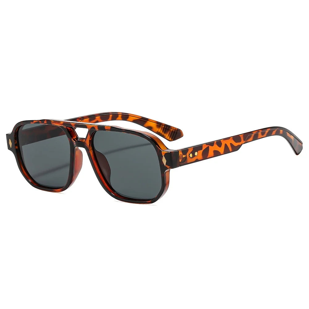 Tortoiseshell acetate frame detail of retro aviator sunglasses with blue lens coating
